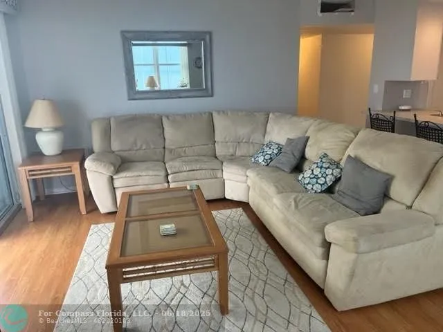 a living room with a couch and a potted plant