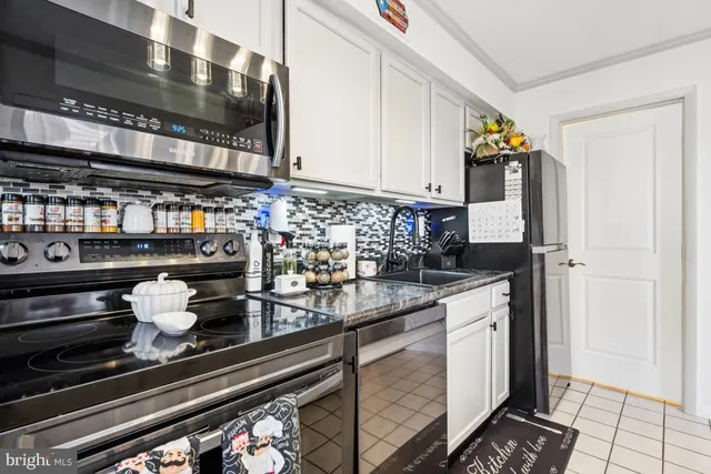 a kitchen with a stove and cabinets