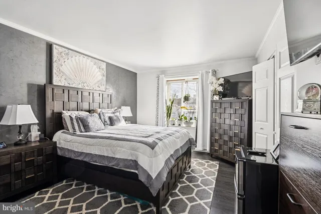 a bedroom with a large bed and a window