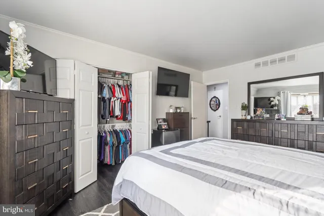 a bed room with a bed and a television