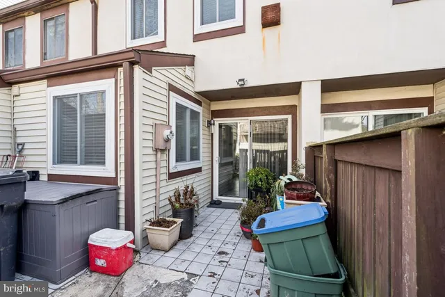 a view of a patio with dining table and chairs potted plants
