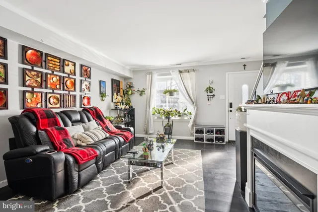 a living room with furniture a rug and gym equipment