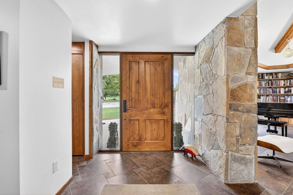 1080 North Greenbrier Road Nocona, TX 76255 - Photo 4 of 40 Solid wood-panel entry door with sidelight windows
