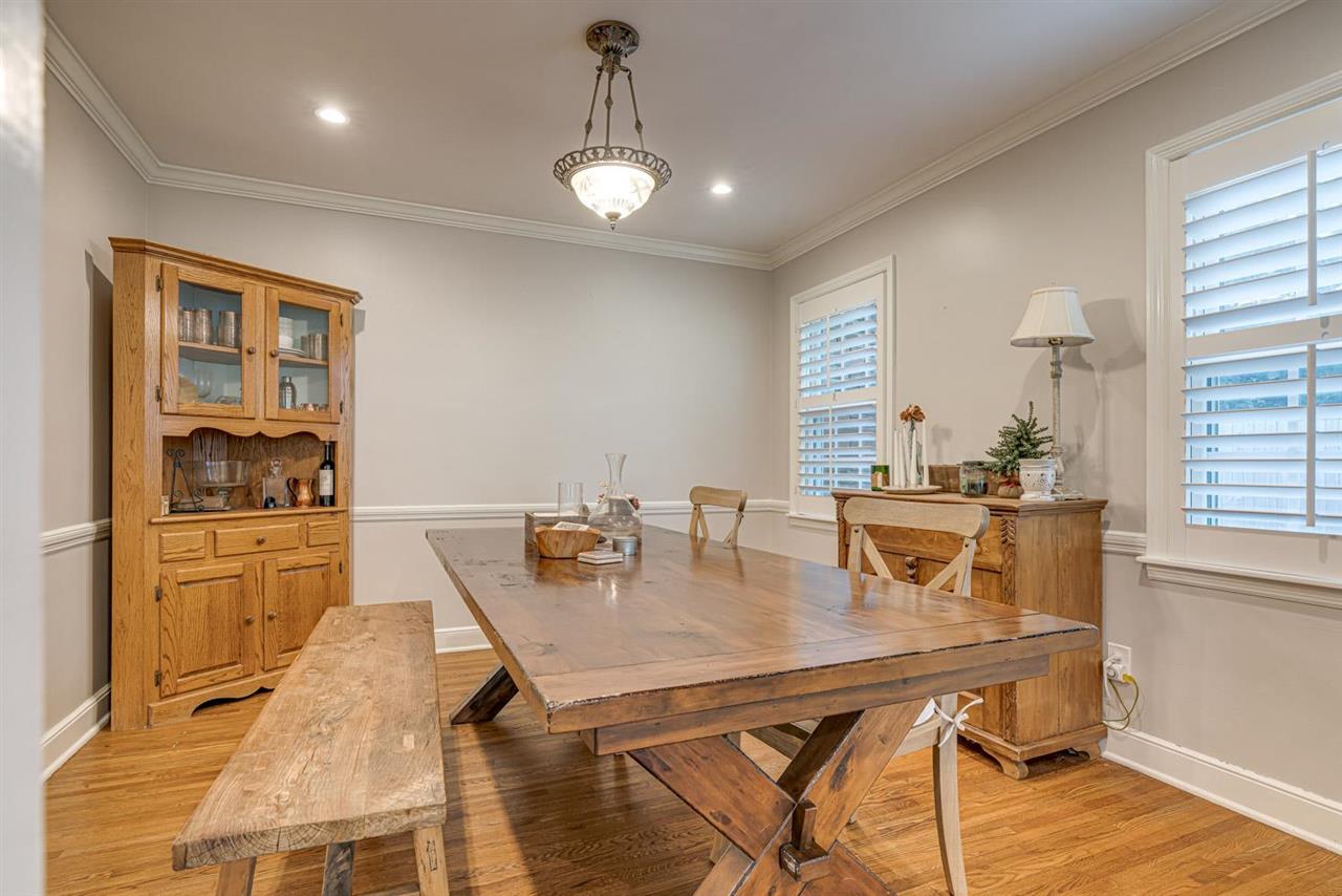 80 East Carlos Road Memphis, TN 38117 - Photo 7 of 25 a dining room with stainless steel appliances kitchen island granite countertop a table chairs and a refrigerator