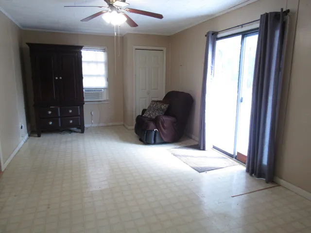 an empty room with windows and closet