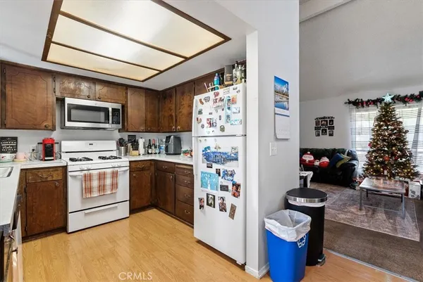 a bedroom with a bed a computer on the desk and a window