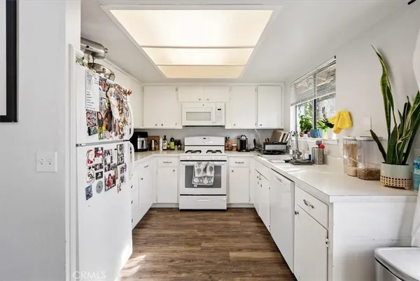 a view of a room with lots of furniture and white walls