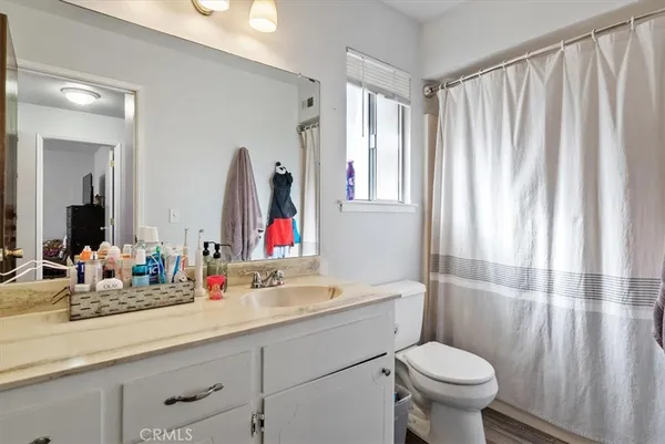 a view of washer and dryer with kitchen in the background