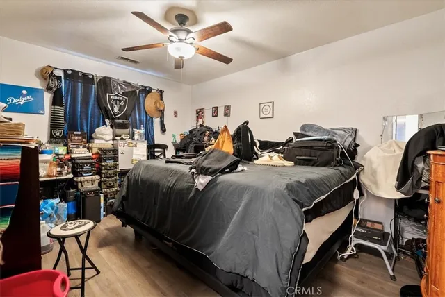 a kitchen with stainless steel appliances a refrigerator sink and white cabinets