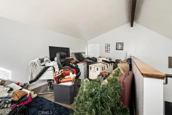 a view of roof deck with wooden fence and trees
