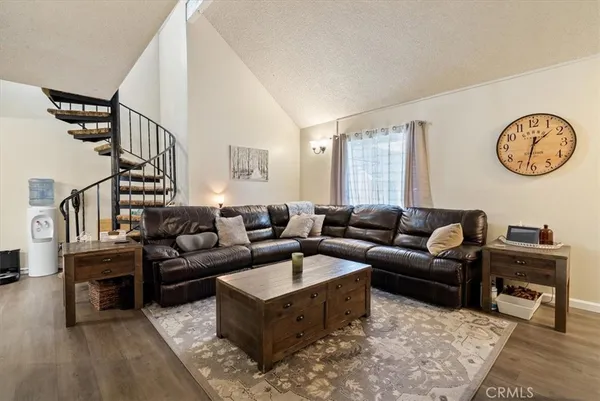 a view of a house with backyard and sitting area