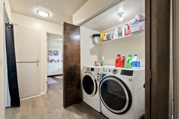 a view of a backyard with table and chairs with a fire pit and a large tree