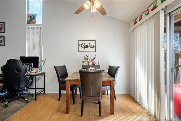 a bedroom with a bed a computer on the desk and a window