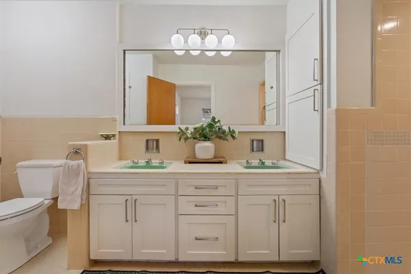 a bathroom with a double vanity sink and a mirror