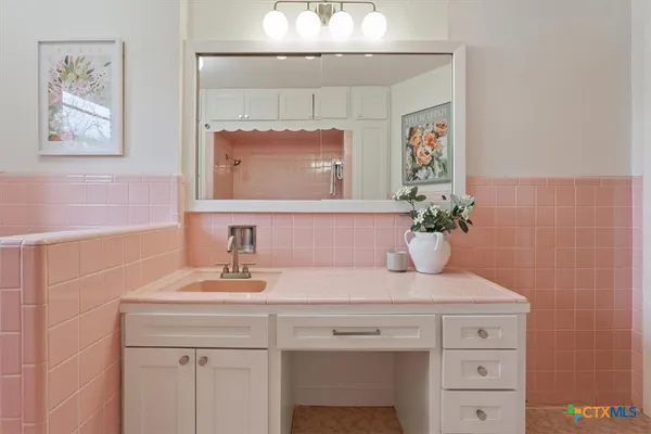 a bathroom with a sink and a mirror