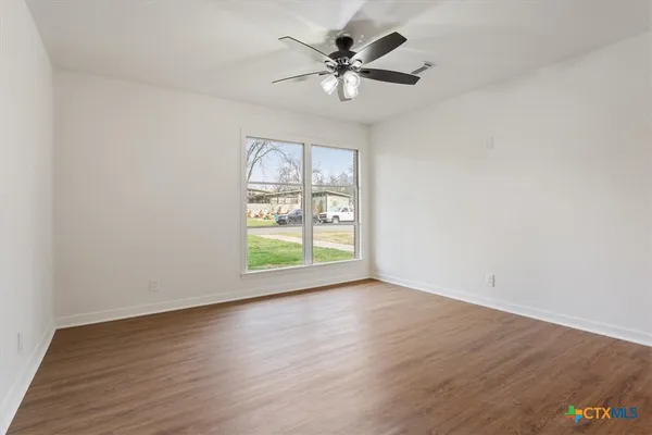 wooden floor in an empty room with a window