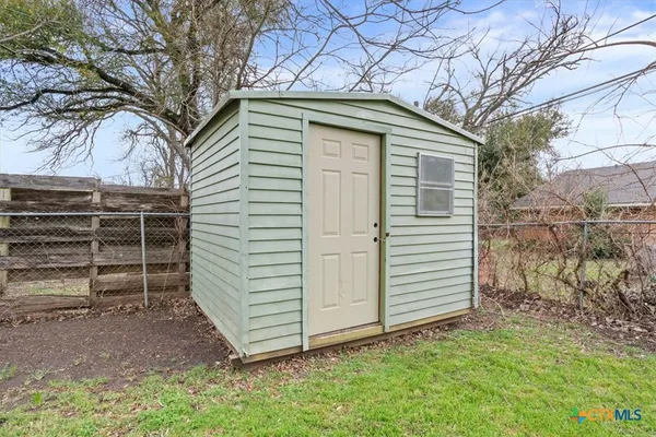 a small white house with a white roof and a yard