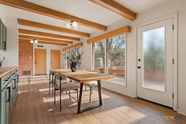 a view of a dining room with furniture window and wooden floor