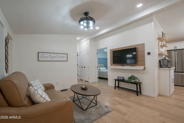 a living room with furniture a fireplace and a flat screen tv
