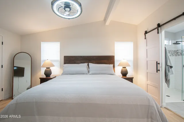 a bedroom with a bed and wooden floor