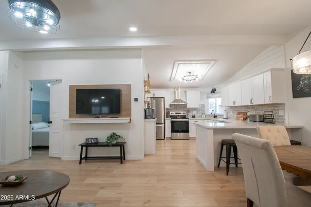 a kitchen with refrigerator and cabinets