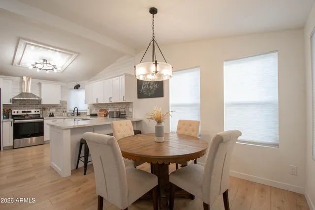 a kitchen with white cabinets stainless steel appliances and sink