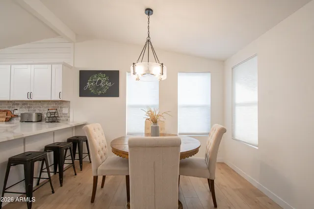a kitchen with granite countertop white cabinets and sink