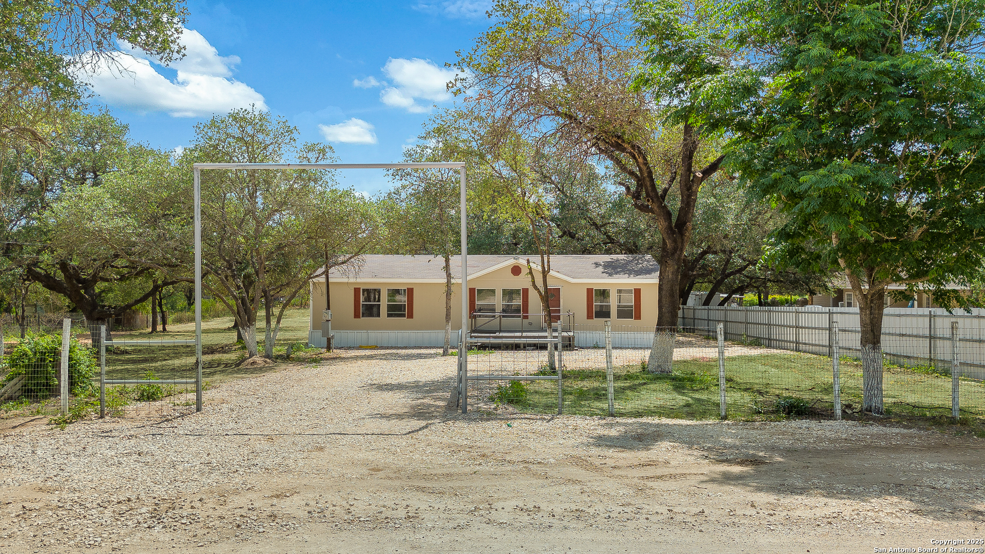 823 County Road 6850 Lytle, TX 78052 - Photo 1 of 33 a front view of a house with a yard and large trees