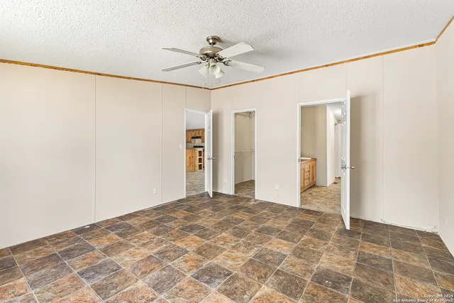 a view of a big room with a chandelier fan and closet
