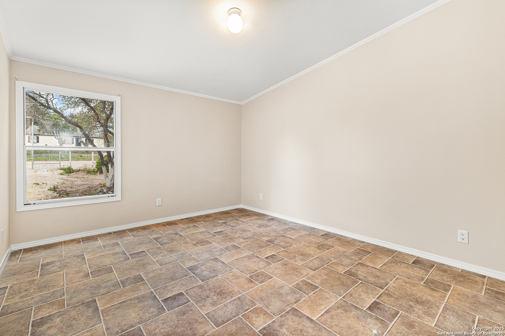 823 County Road 6850 Lytle, TX 78052 - Photo 21 of 33 an empty room with a window
