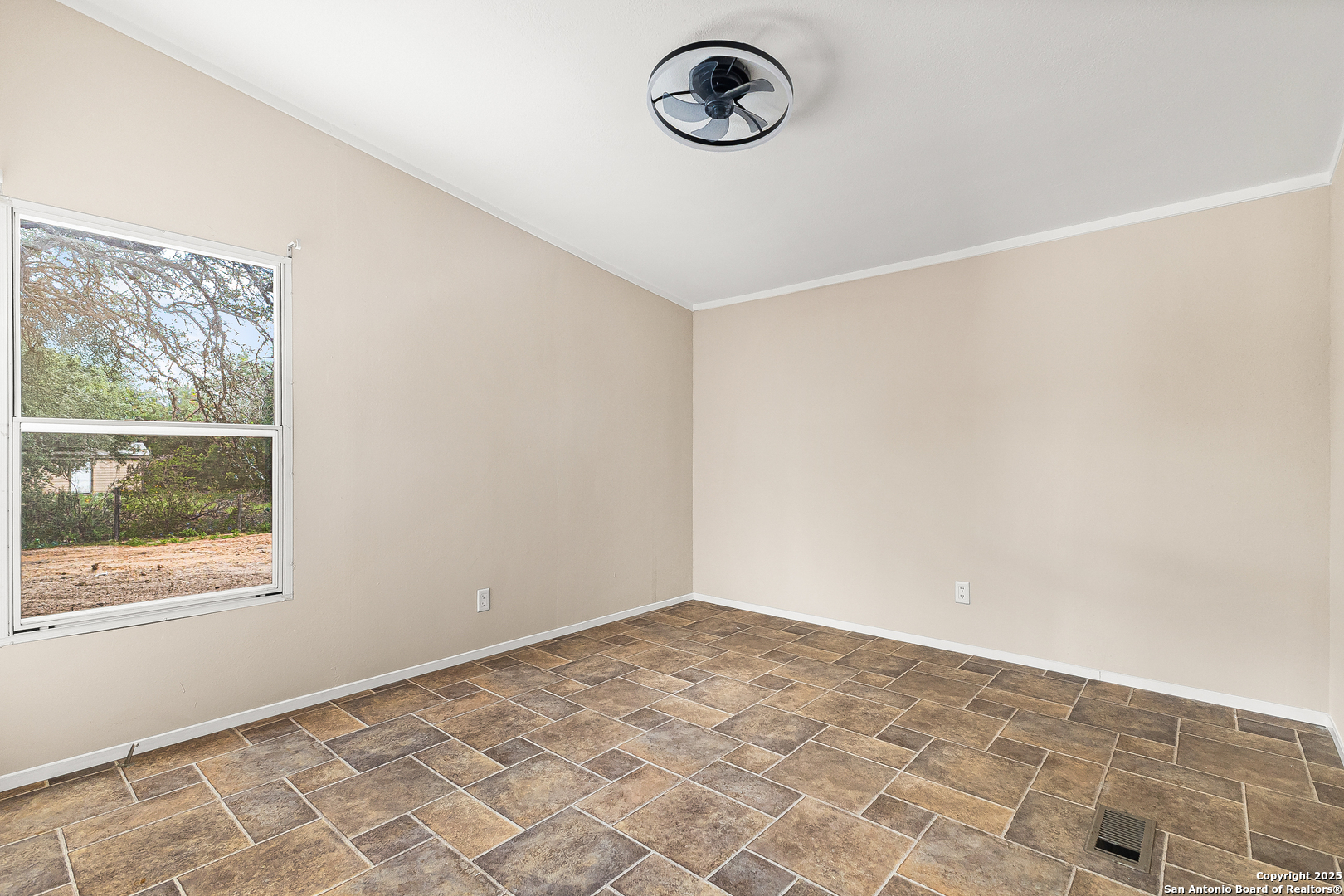 823 County Road 6850 Lytle, TX 78052 - Photo 22 of 33 an empty room with a empty space and a window