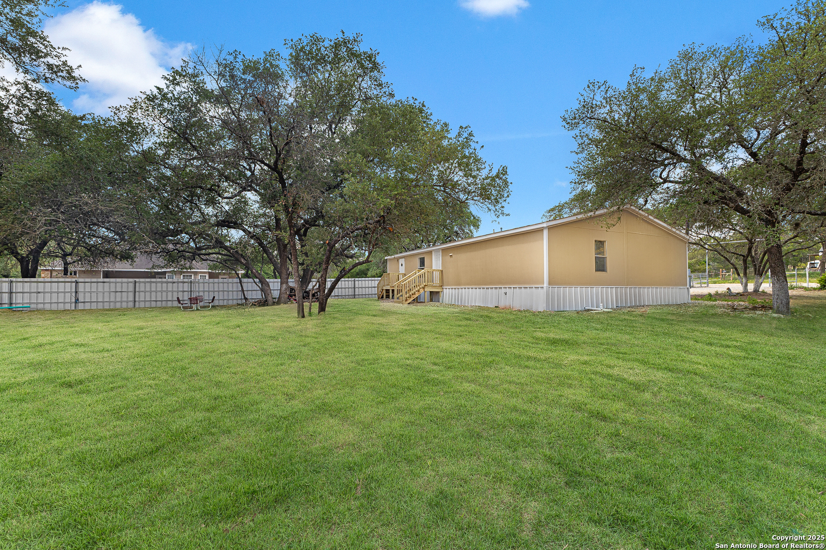 823 County Road 6850 Lytle, TX 78052 - Photo 25 of 33 a view of a house with a backyard