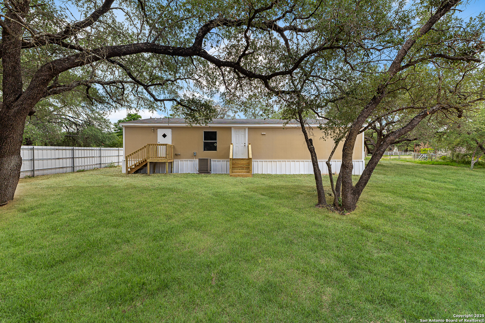 823 County Road 6850 Lytle, TX 78052 - Photo 26 of 33 a front view of a house with garden