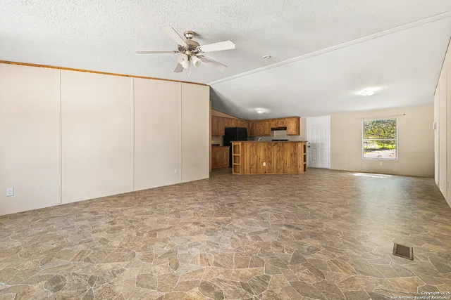 a view of a livingroom with furniture and chandelier fan