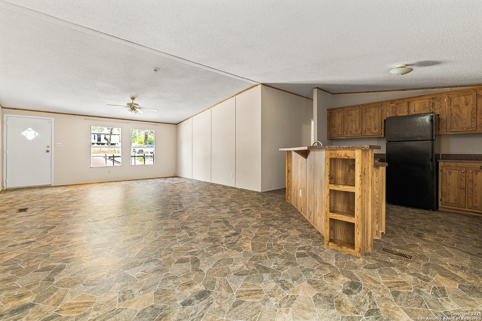 823 County Road 6850 Lytle, TX 78052 - Photo 10 of 33 a view of a refrigerator in kitchen and empty room