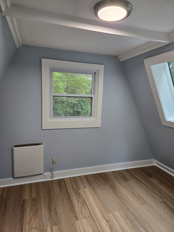 121 Amherst Road Pelham, MA 01002 - Photo 11 of 31 a view of an empty room with wooden floor and a window