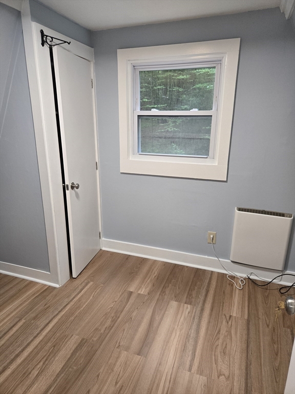 121 Amherst Road Pelham, MA 01002 - Photo 12 of 31 a view of an empty room with wooden floor and a window