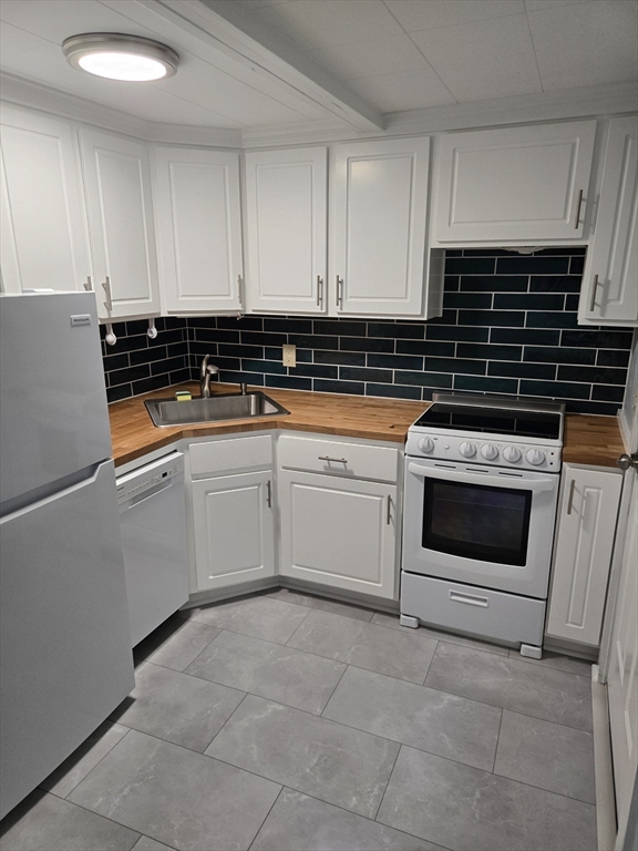 121 Amherst Road Pelham, MA 01002 - Photo 3 of 31 a white kitchen with granite top and stainless steel appliances