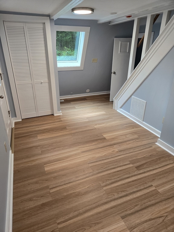121 Amherst Road Pelham, MA 01002 - Photo 5 of 31 a view of an empty room with wooden floor and a window