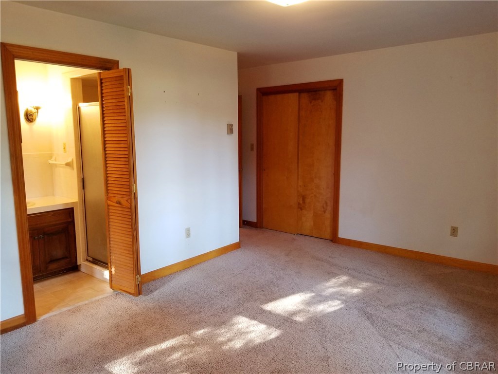 7449 Joseph Lewis Road Hayes, VA 23072 - Photo 27 of 32 Master Bedroom with full bath and 1 of the 2 closets can be seen here.