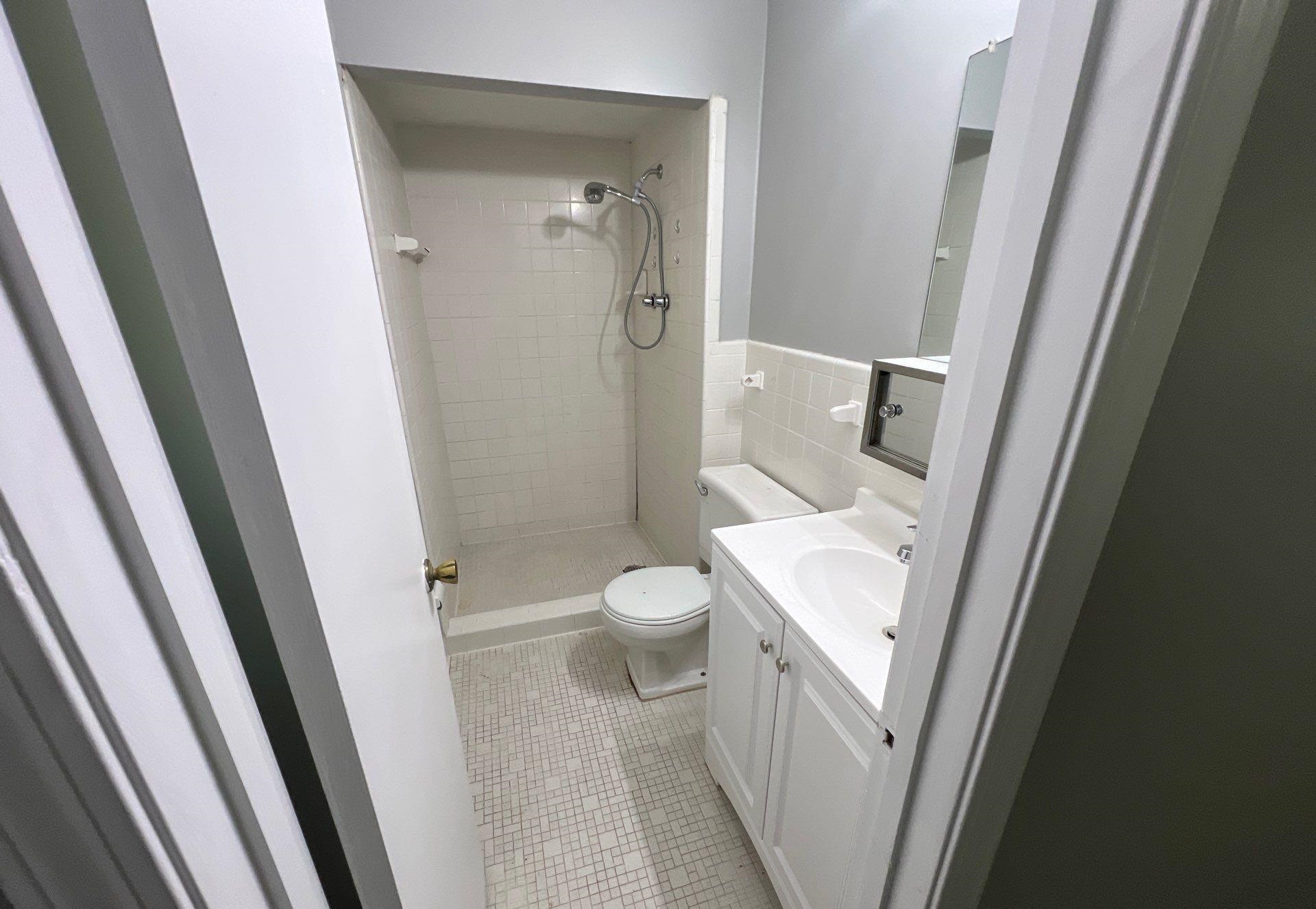 4936 Warrington Road Memphis, TN 38118 - Photo 5 of 13 a bathroom with a sink a toilet and a shower