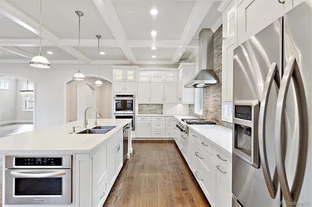 a kitchen with stainless steel appliances a stove sink and refrigerator
