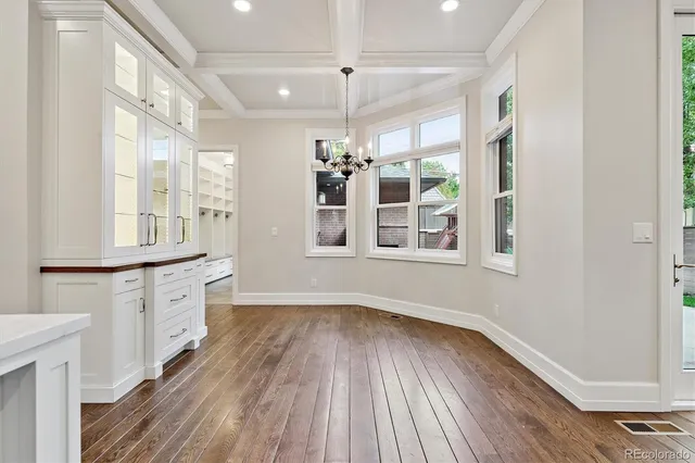 a kitchen with wooden floors and a window