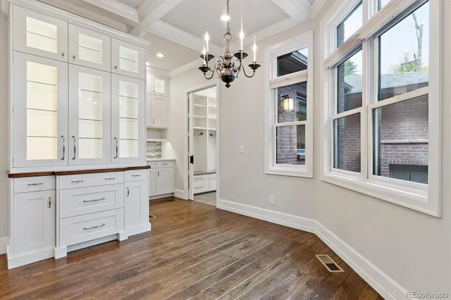 a spacious bathroom with a double vanity sink a large mirror and a shower