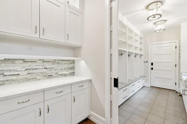 a view of a kitchen with white cabinets
