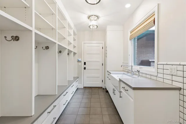 a bathroom with a double vanity sink and mirror with shower
