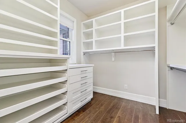 a view of walk in closet with empty racks