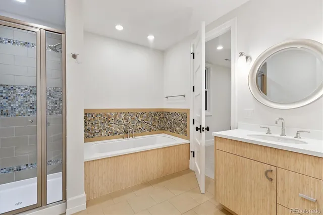 a view of a patio with couches table and chairs with wooden fence