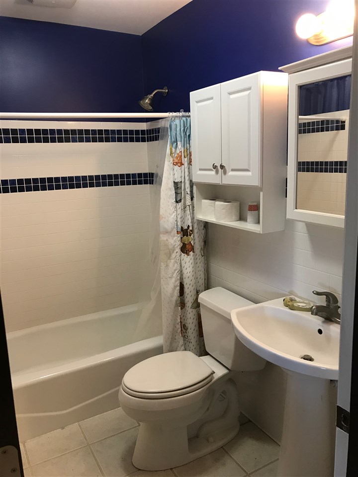 7632 North River Road Byron, IL 61010 - Photo 12 of 15 a bathroom with a toilet a sink and bathtub