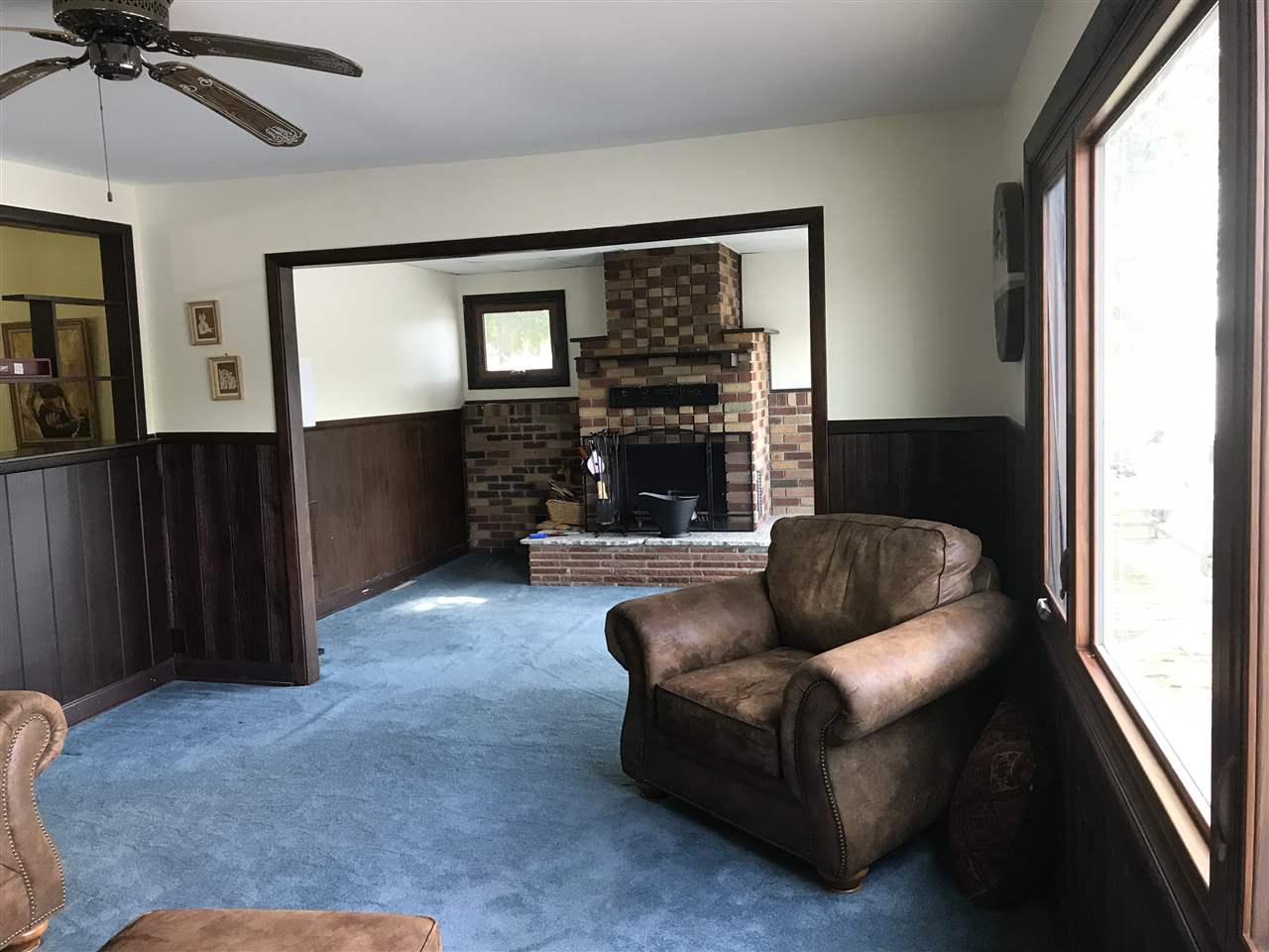 7632 North River Road Byron, IL 61010 - Photo 8 of 15 a living room with furniture and a fireplace